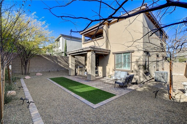 back of house with an outdoor hangout area and a patio