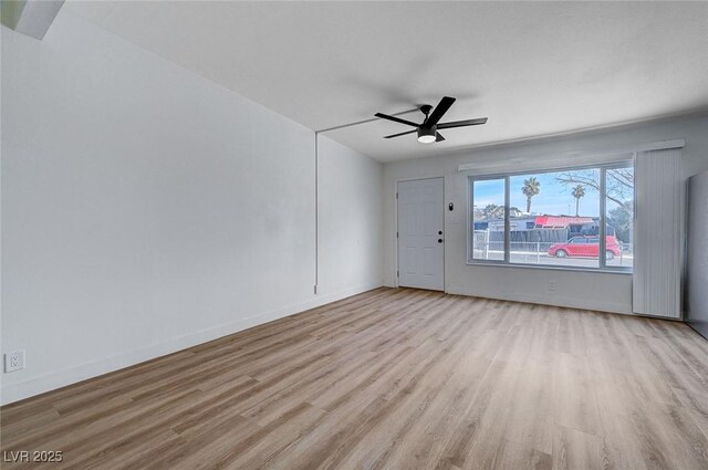 unfurnished room with light wood-type flooring and ceiling fan