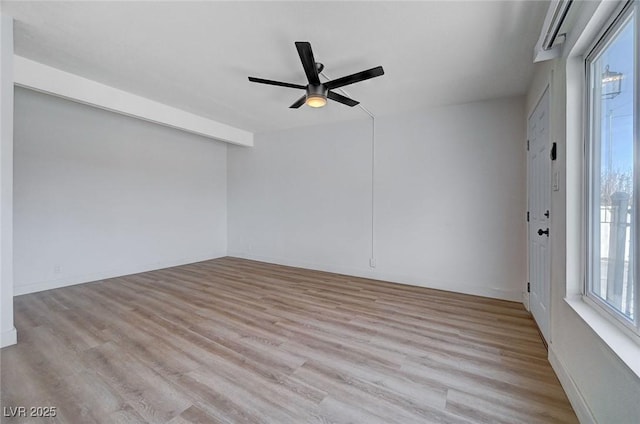 empty room featuring ceiling fan and light hardwood / wood-style floors