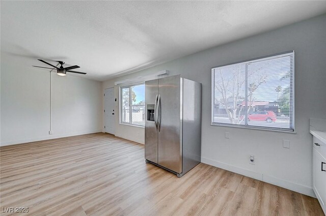 kitchen featuring ceiling fan, light wood-type flooring, and stainless steel fridge