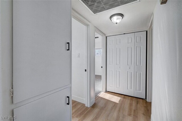 corridor with light wood-type flooring