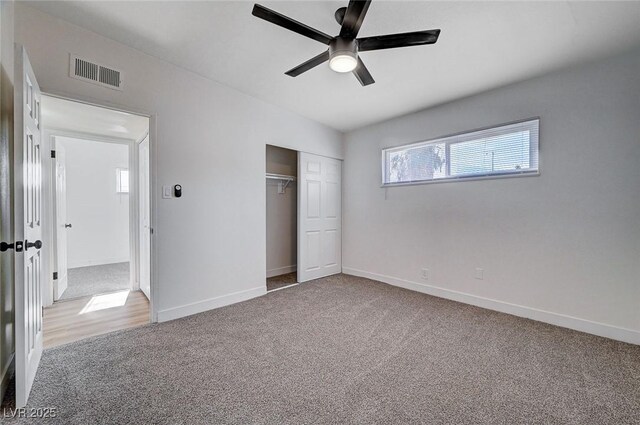 unfurnished bedroom featuring a closet, ceiling fan, and carpet