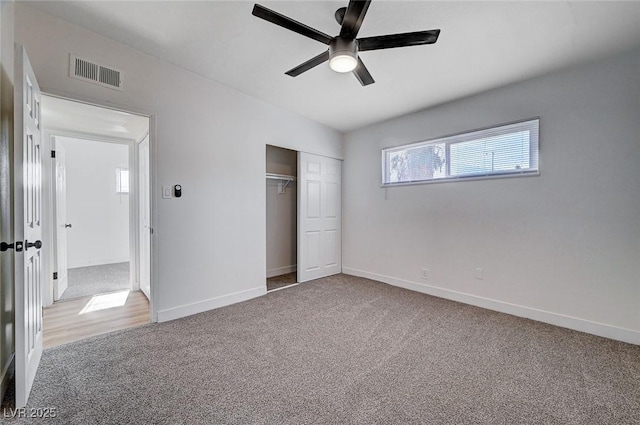 unfurnished bedroom featuring ceiling fan, carpet, and a closet