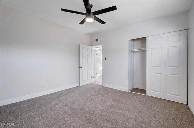 unfurnished bedroom with ceiling fan, a closet, and carpet floors