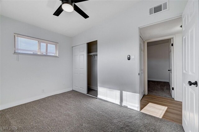 unfurnished bedroom featuring ceiling fan, a closet, and carpet