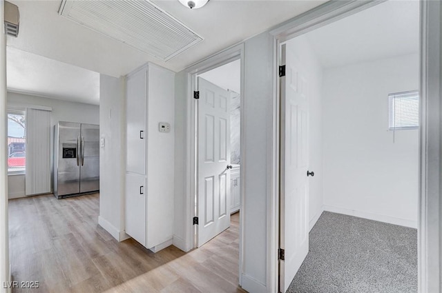 corridor with light hardwood / wood-style flooring