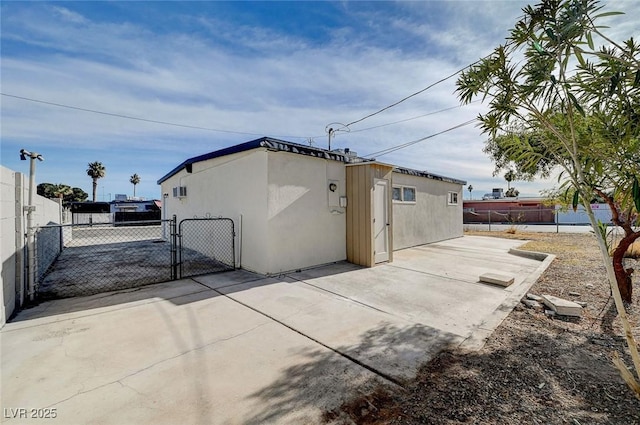 view of side of home with a patio area