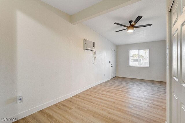 empty room featuring light wood-type flooring, ceiling fan, a wall mounted air conditioner, and vaulted ceiling with beams