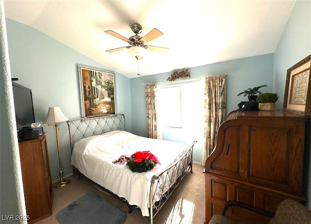 carpeted bedroom with ceiling fan and vaulted ceiling