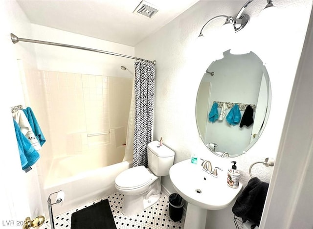 full bathroom with toilet, tile patterned floors, sink, and shower / bath combo with shower curtain