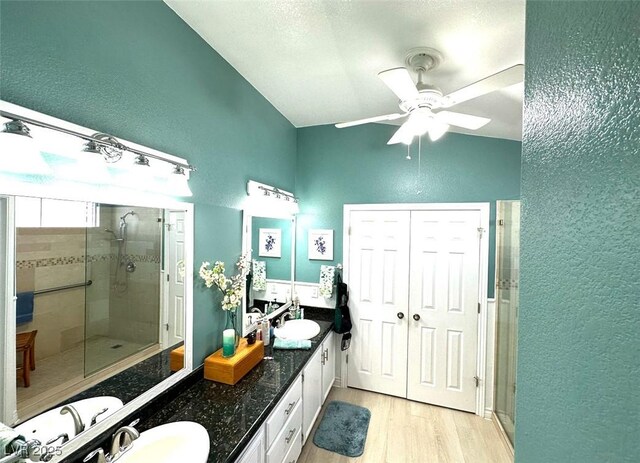 bathroom featuring an enclosed shower, vanity, ceiling fan, and hardwood / wood-style floors