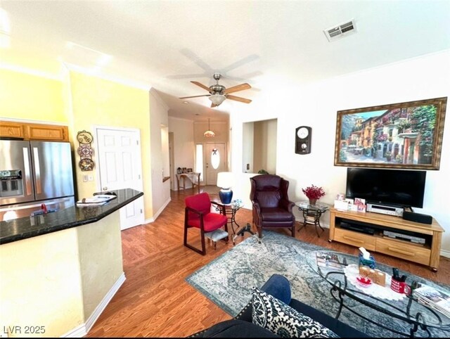 living room featuring ceiling fan and hardwood / wood-style floors