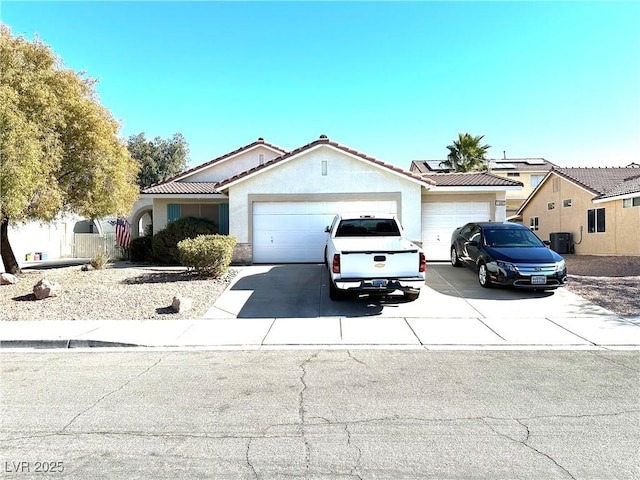 view of front of house with a garage and cooling unit