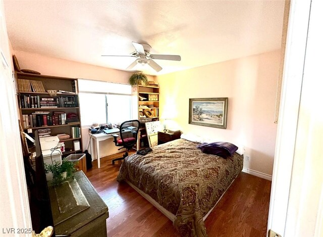 bedroom featuring ceiling fan and dark hardwood / wood-style floors