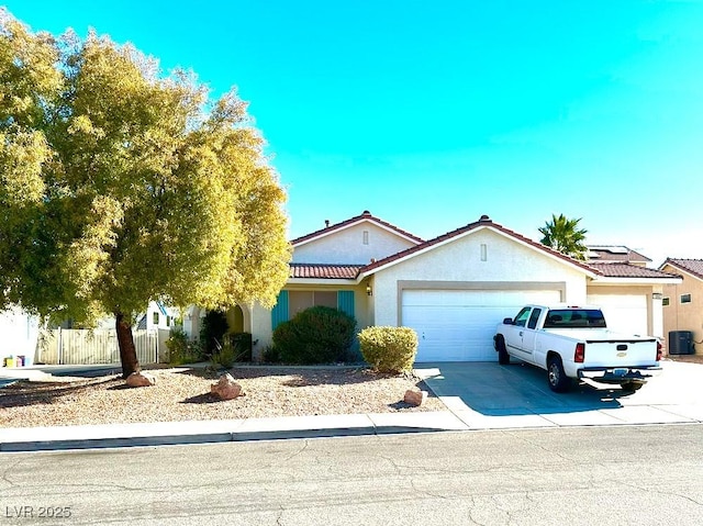 view of front of house with a garage and central AC