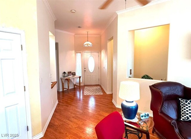 entrance foyer featuring crown molding and hardwood / wood-style flooring