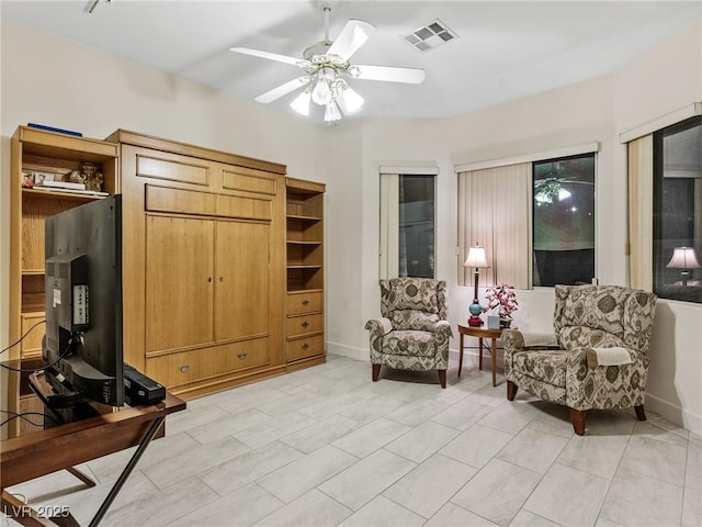 living area featuring ceiling fan