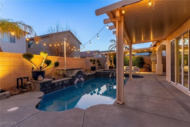 pool at dusk with a patio area