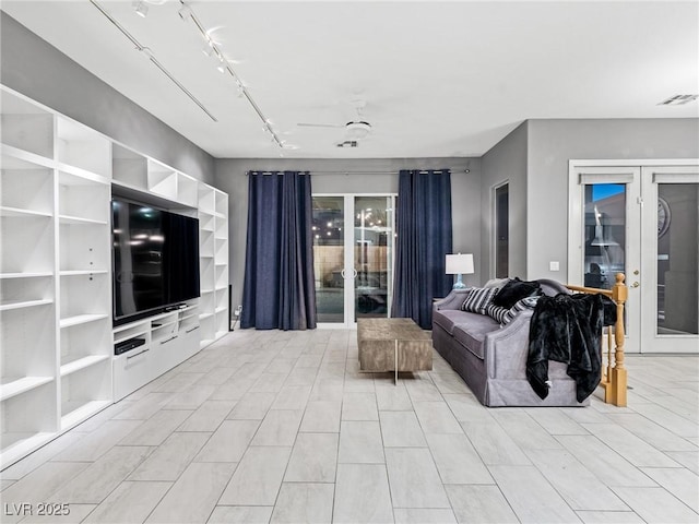 living room with french doors, rail lighting, and ceiling fan