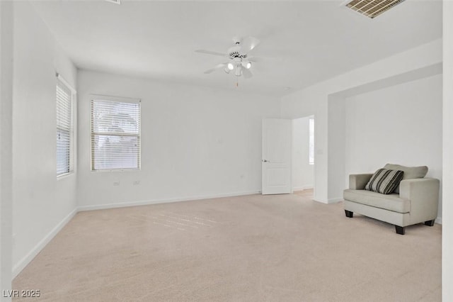 unfurnished room featuring light carpet and ceiling fan