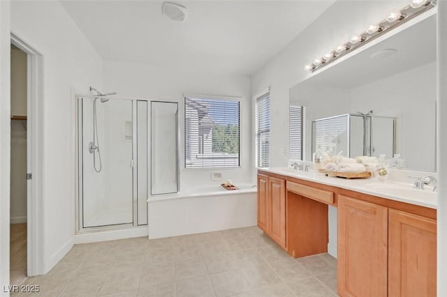 bathroom featuring tile patterned floors, vanity, and shower with separate bathtub