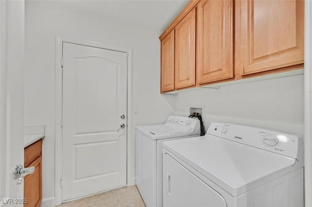 washroom featuring light tile patterned floors, cabinets, and independent washer and dryer