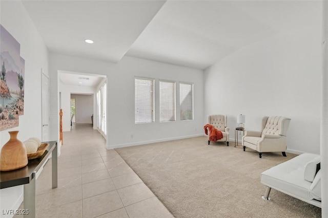 living area featuring lofted ceiling and light tile patterned floors