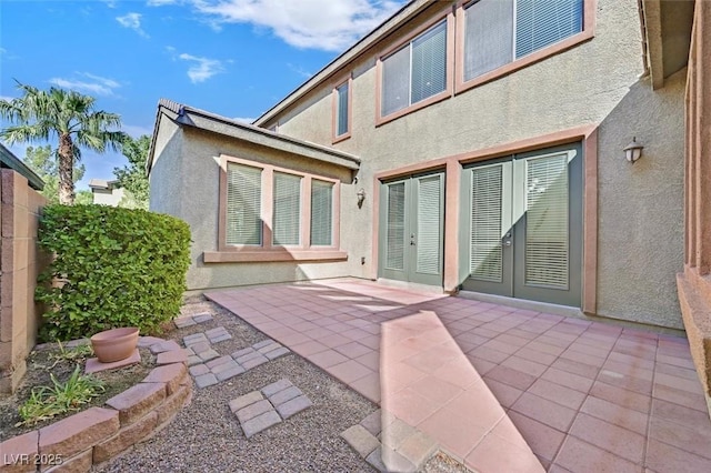 rear view of house featuring french doors and a patio