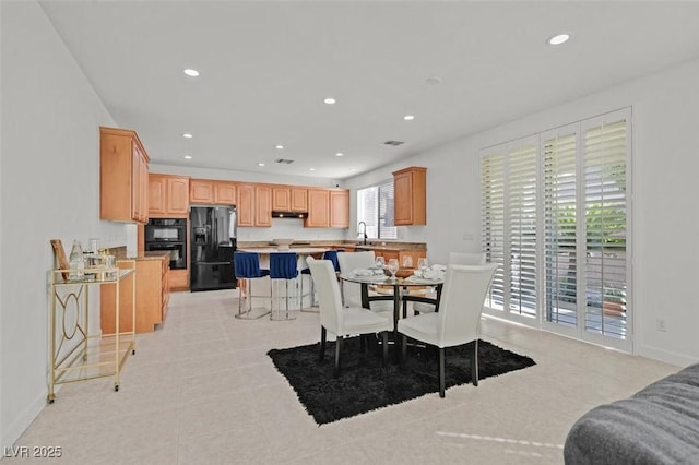 dining space with sink and light tile patterned floors