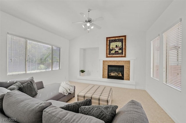 living room featuring ceiling fan and lofted ceiling