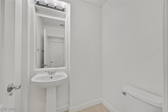 bathroom with sink, tile patterned flooring, and toilet