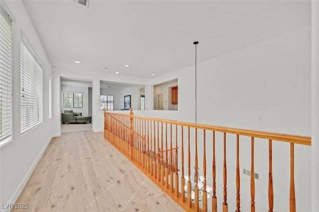 hallway with light hardwood / wood-style flooring