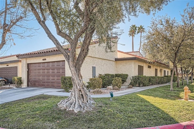 view of front of property with a front yard and a garage