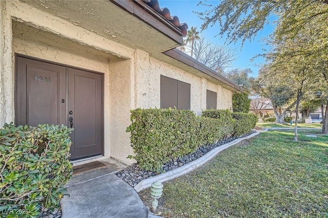 entrance to property with a yard