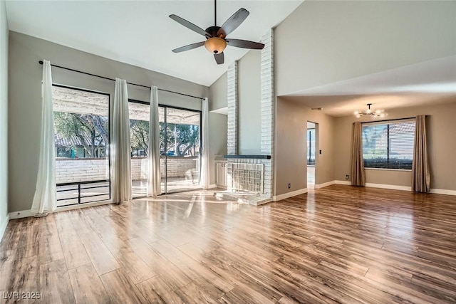 unfurnished living room with ceiling fan, a healthy amount of sunlight, and hardwood / wood-style flooring