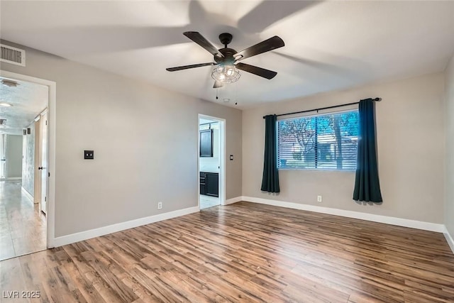 spare room with ceiling fan and wood-type flooring