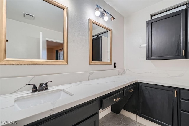 bathroom with tile patterned floors and vanity