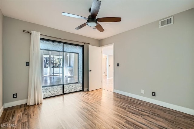 spare room featuring ceiling fan and light hardwood / wood-style flooring