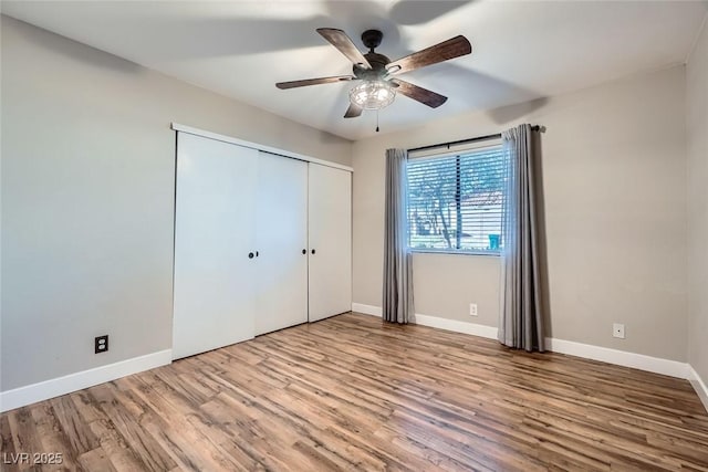 unfurnished bedroom with ceiling fan, light hardwood / wood-style floors, and a closet