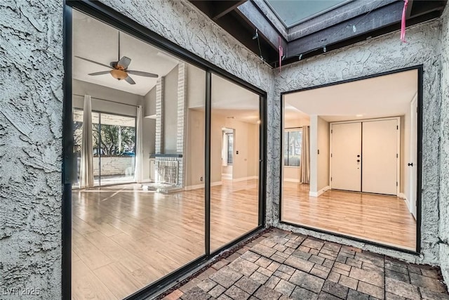 interior space with ceiling fan and vaulted ceiling