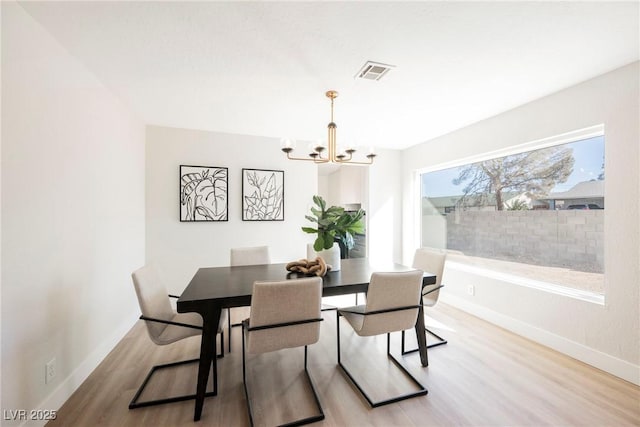 dining room featuring a chandelier and light wood-type flooring