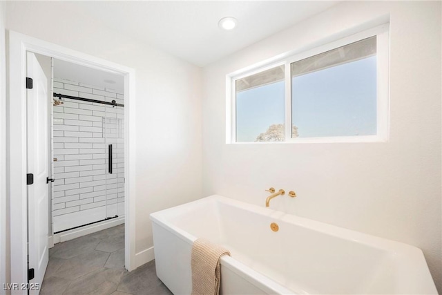 bathroom featuring tile patterned floors and separate shower and tub