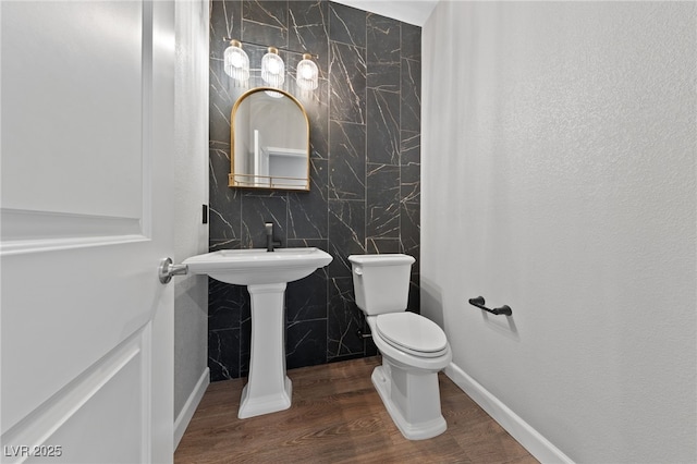 bathroom featuring toilet and hardwood / wood-style flooring