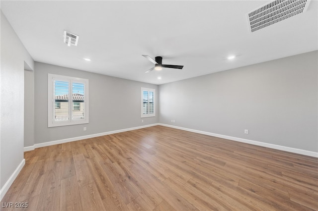 empty room featuring ceiling fan and light hardwood / wood-style flooring