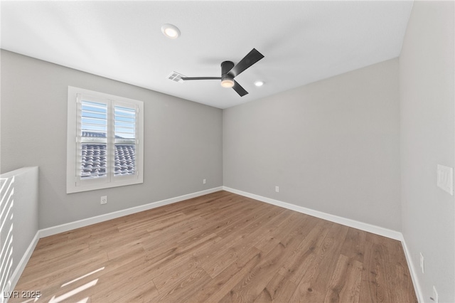 spare room with light wood-type flooring and ceiling fan