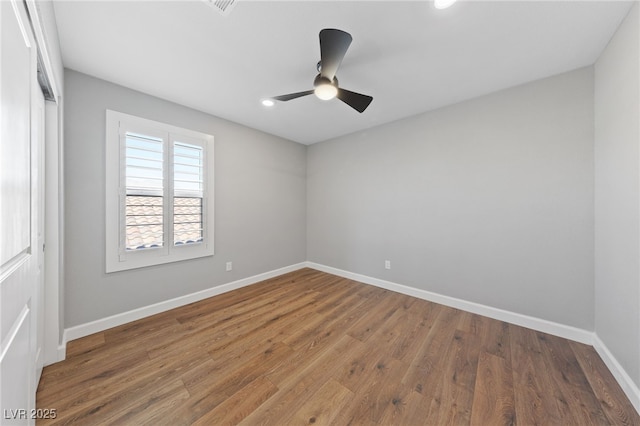 unfurnished room with ceiling fan and hardwood / wood-style flooring