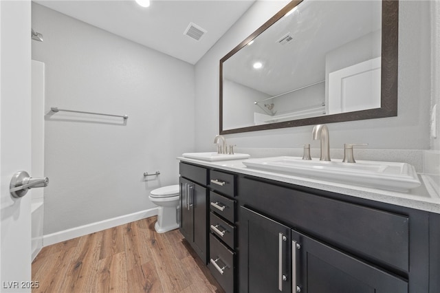 bathroom featuring hardwood / wood-style floors, vanity, and toilet