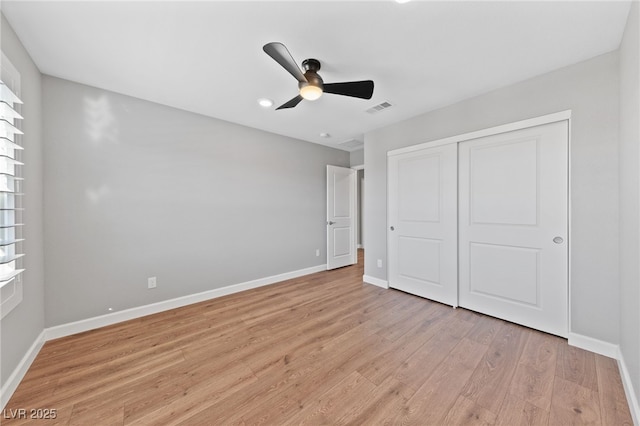 unfurnished bedroom featuring a closet, ceiling fan, and light hardwood / wood-style flooring