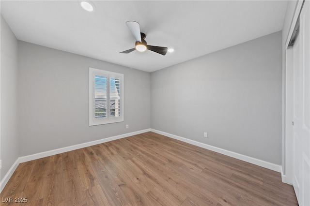 spare room featuring hardwood / wood-style floors and ceiling fan