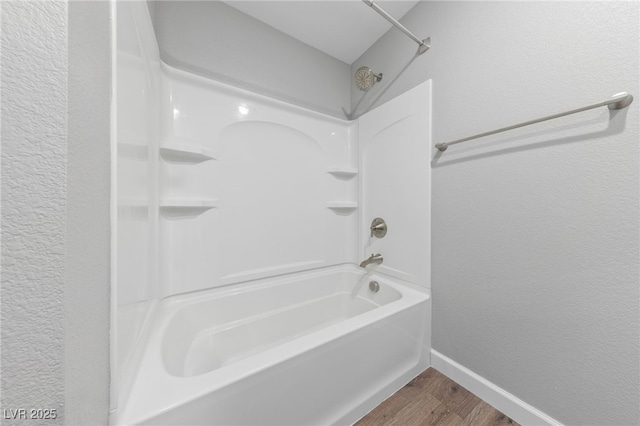 bathroom with wood-type flooring and bathtub / shower combination